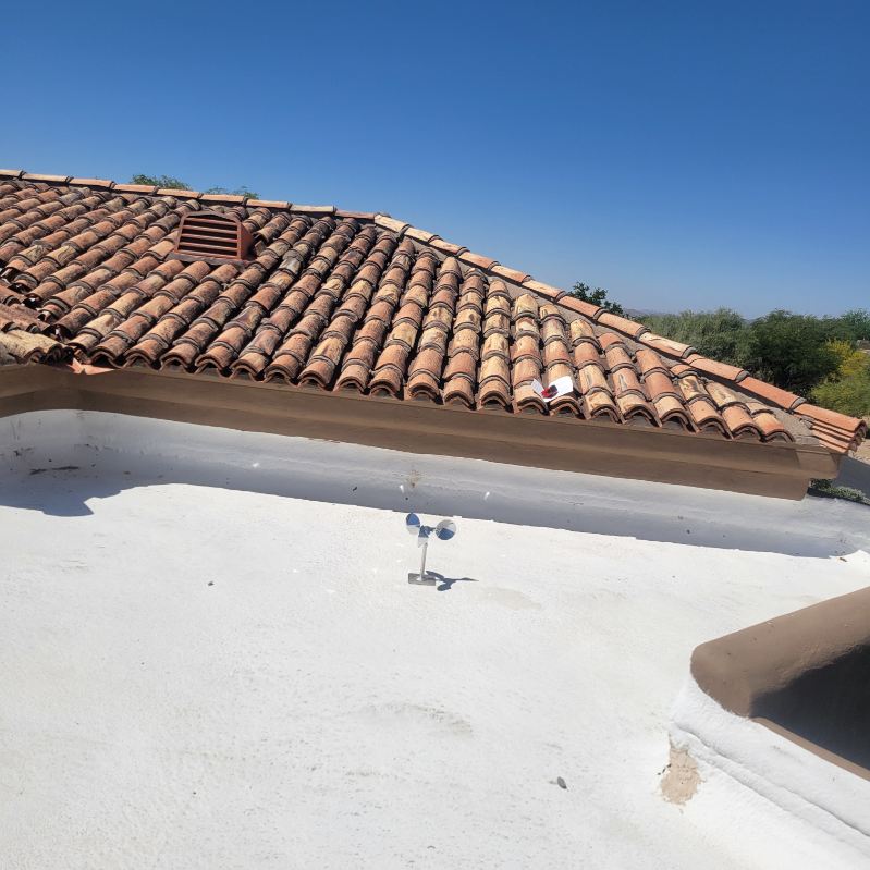 Junction between a flat foam roof and tile roof where interior ceiling leaks often originate.