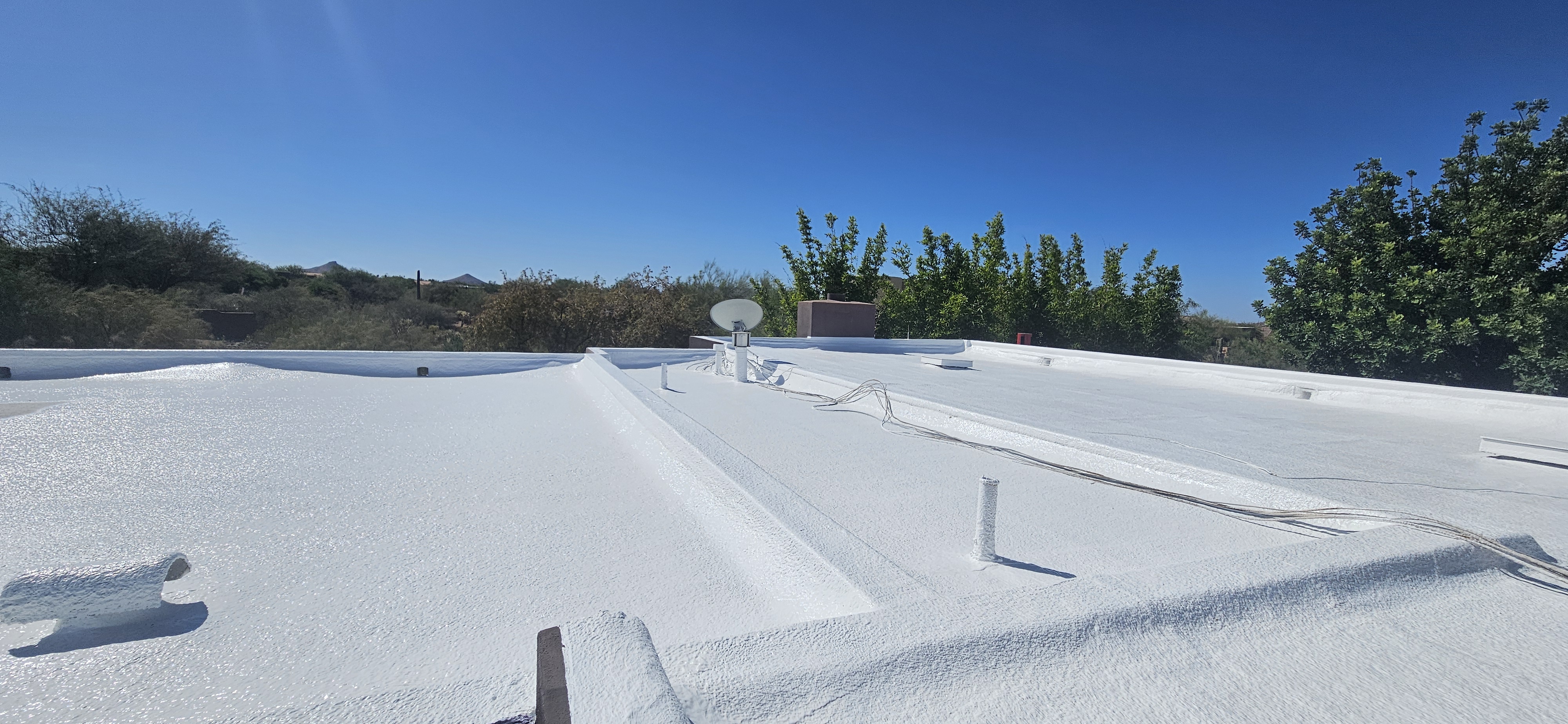 Bright white elastomeric coating on a foam flat roof in Scottsdale, Arizona.