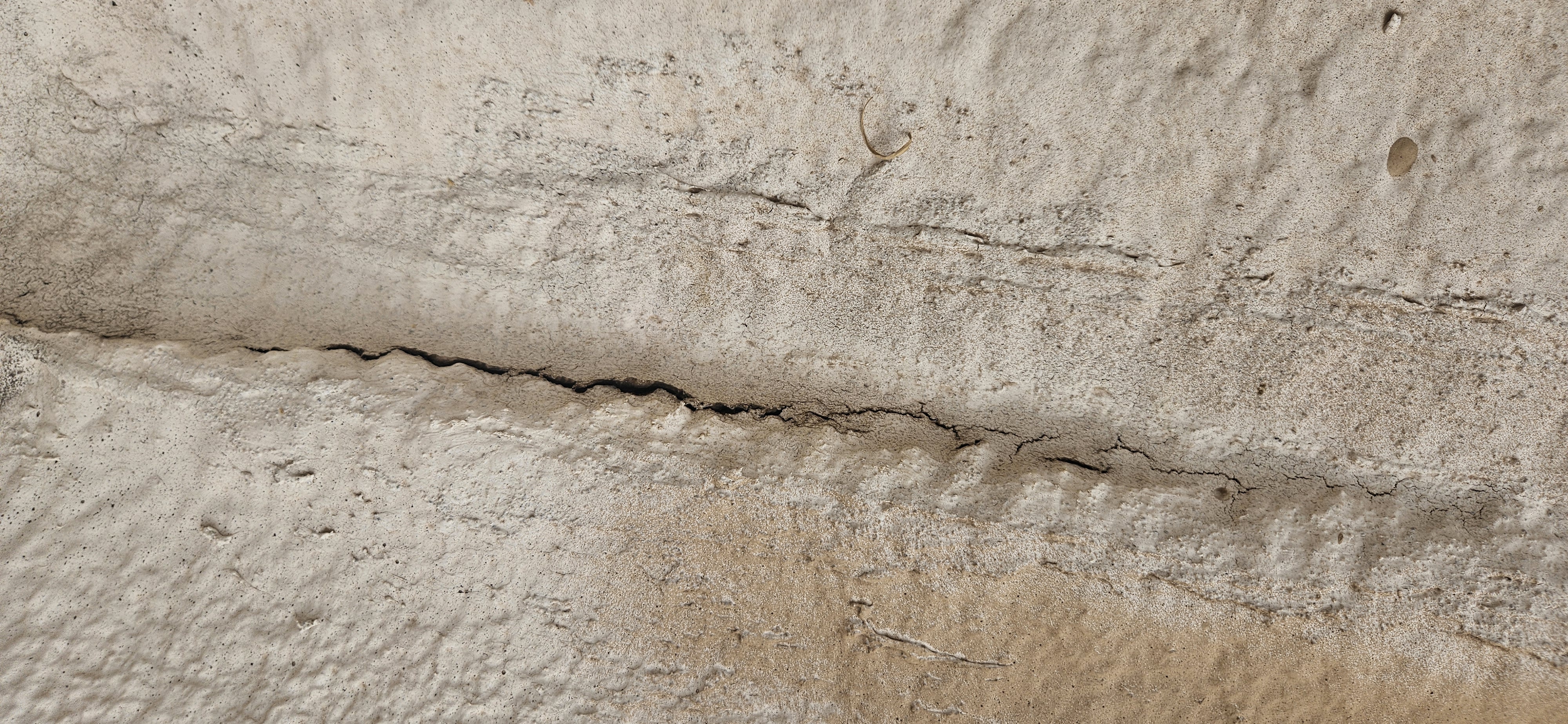 Close-up of a cracked, weathered foam roof showing damage that needs repair in Phoenix.