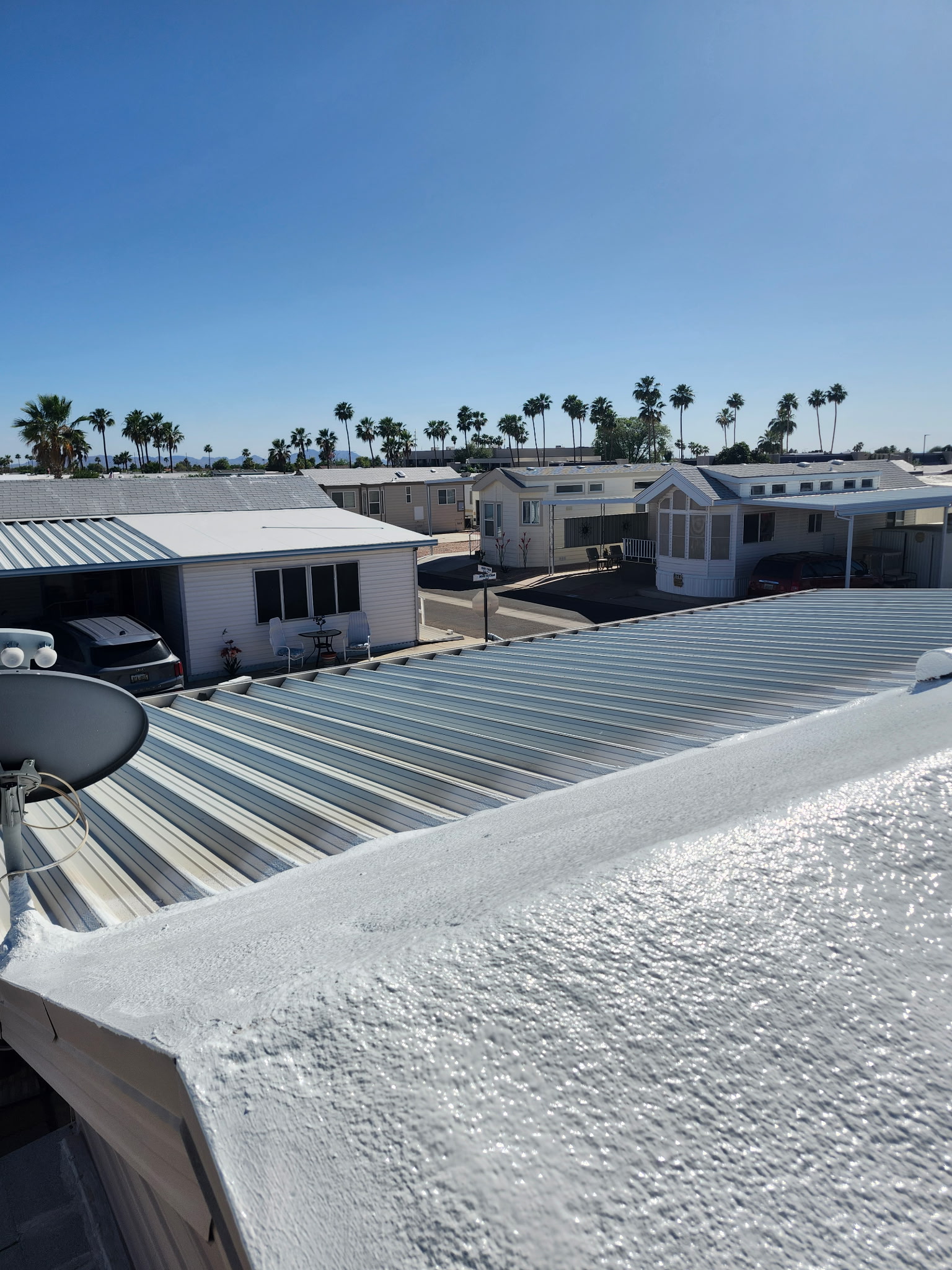 A bright white foam roof recoat installed by Durafoam Roofing shines on a commercial flat roof in Phoenix, Arizona.