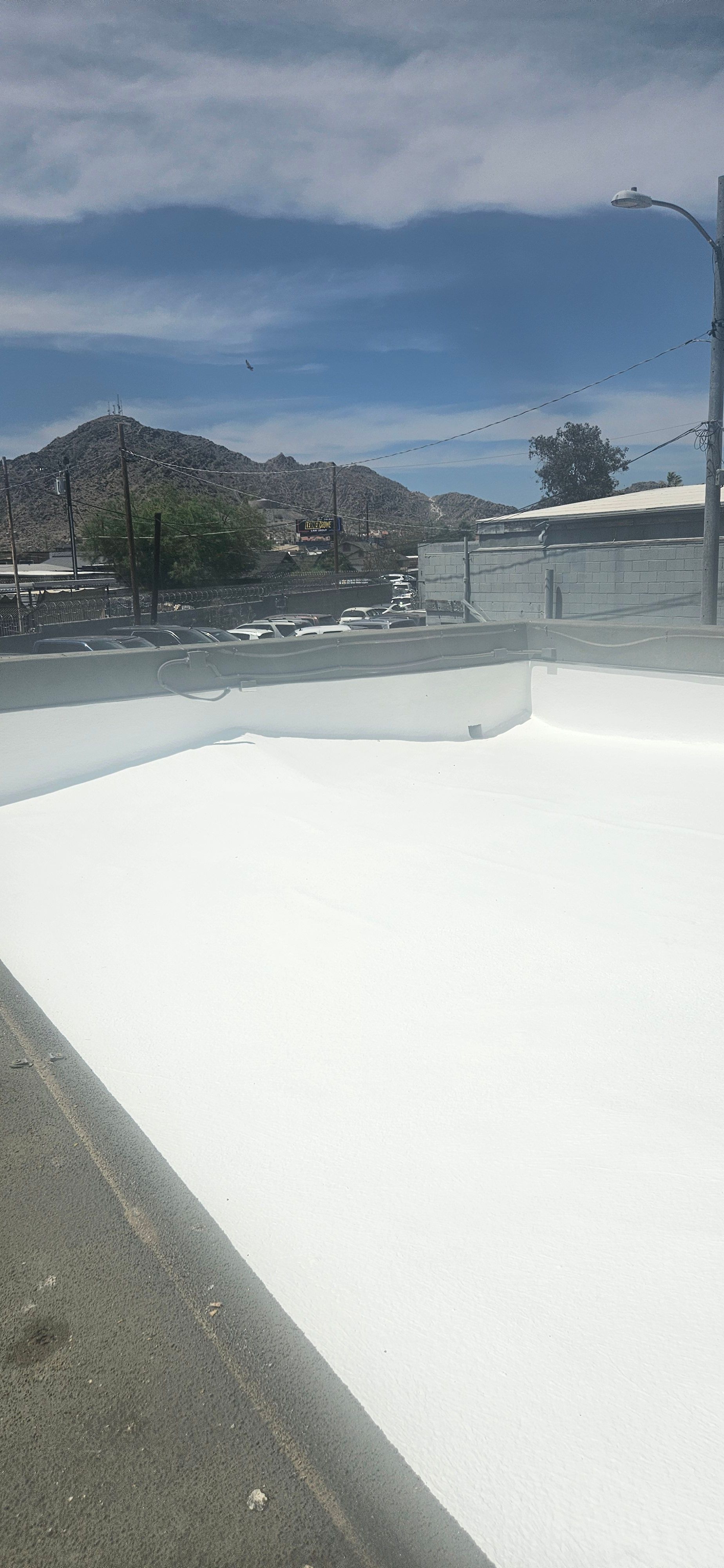 Commercial foam recoat on a flat roof in Phoenix by Durafoam Roofing.