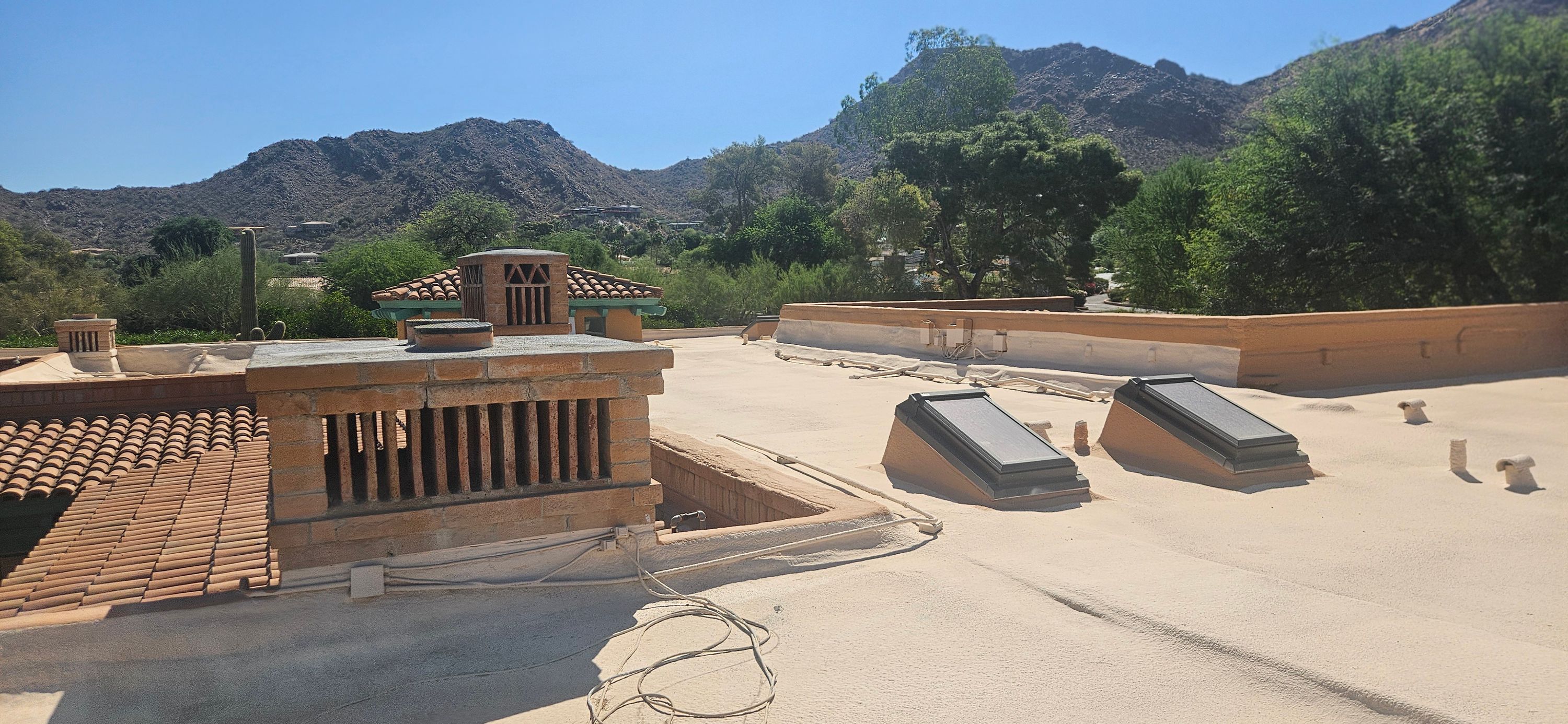Multiple replaced skylights on a white foam flat roof in the Phoenix area